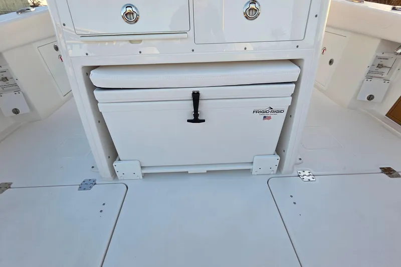 Slide: The Image of 2026 Caymas 34 CT boat interior with Frigid Rigid cooler and storage compartments. - 15