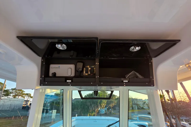 Slide: The Image of 2026 Caymas 34 CT boat interior with Garmin equipment and storage compartments. - 17