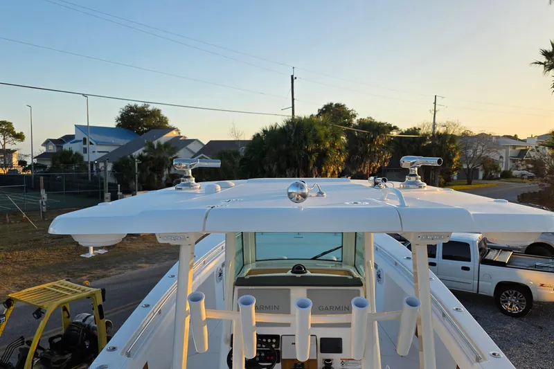 Slide: The Image of 2026 Caymas 34 CT boat with advanced Garmin equipment, docked near residential area at sunset. - 18