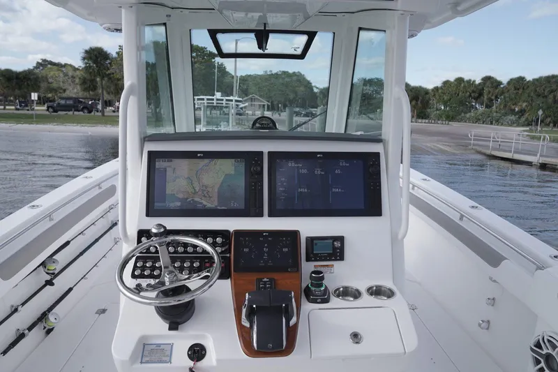 Slide: The Image of 2026 Caymas 34 CT boat on trailer at marina, clear sky background. - 2