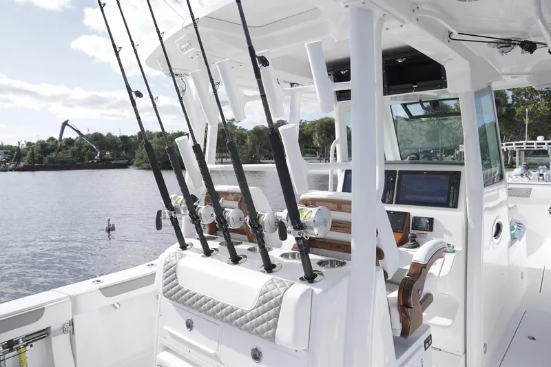 Slide: The Image of 2026 Caymas 34 CT boat on trailer, light blue hull, parked outdoors. - 3