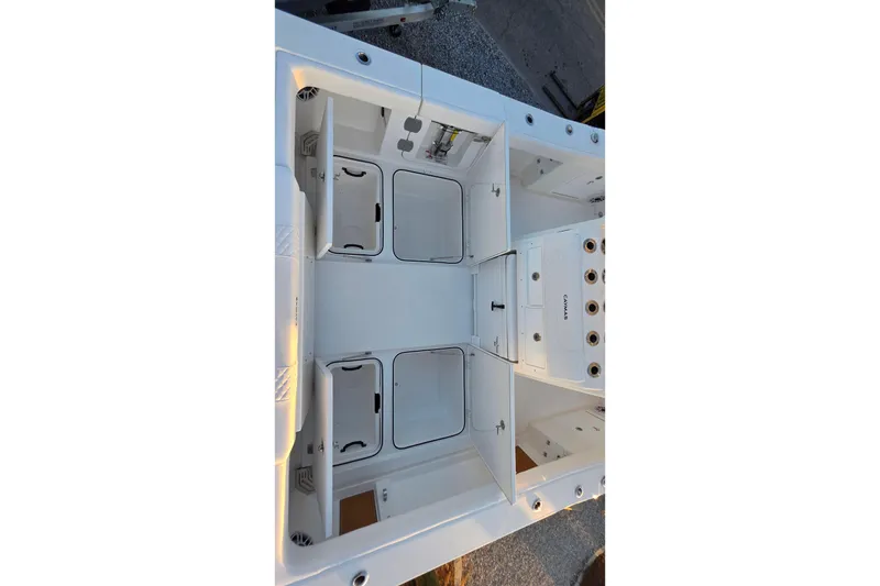 Slide: The Image of 2026 Caymas 34 CT boat interior with storage compartments and fishing rod holders. - 9