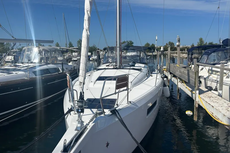 Slide: The Image of 2026 Jeanneau 440 Sun Odyssey sailboat docked in a marina under clear blue skies. - 1
