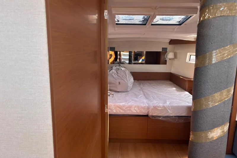 Slide: The Image of Interior cabin of 2026 Jeanneau 440 Sun Odyssey yacht, featuring a cozy bed. - 10