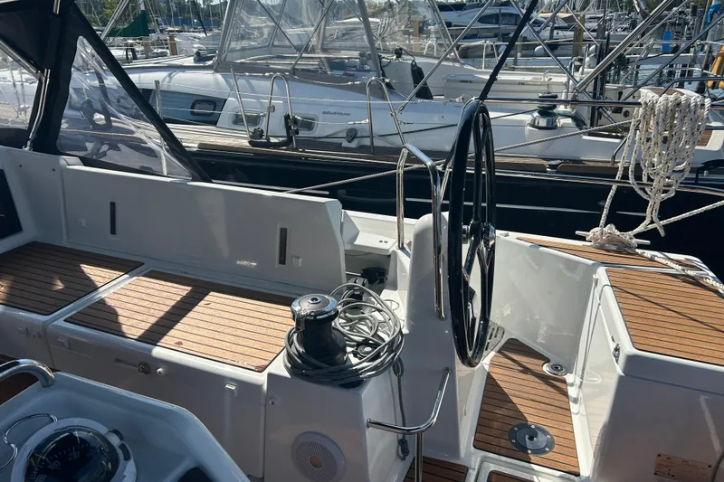 Slide: The Image of Cockpit of 2026 Jeanneau 440 Sun Odyssey sailboat with wooden deck and steering wheel. - 3