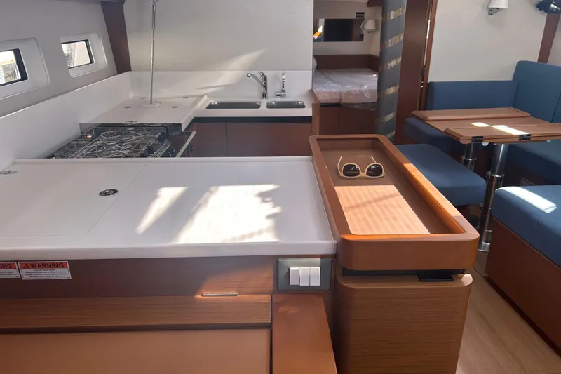 Slide: The Image of Modern interior of 2026 Jeanneau 440 Sun Odyssey yacht with kitchen and seating area. - 6