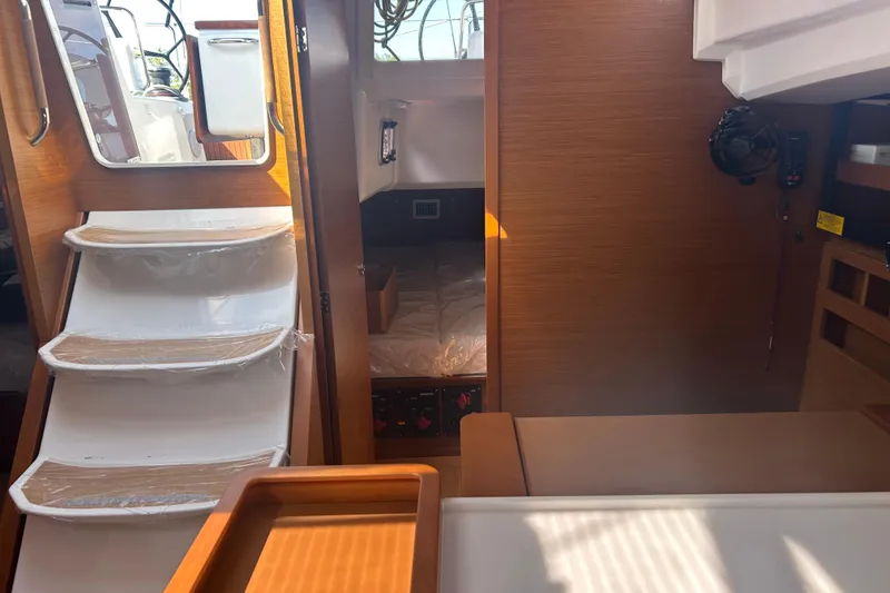 Slide: The Image of Interior of 2026 Jeanneau 440 Sun Odyssey yacht, featuring stairs and cabin area. - 9