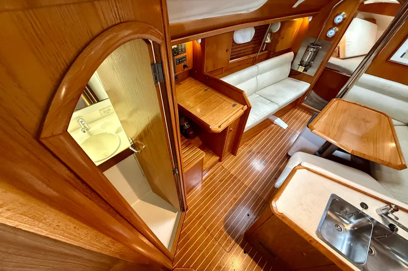 Slide: The Image of Interior of 1997 Jeanneau Sun Odyssey 36.2 sailboat with wood finish and compact kitchen. - 10