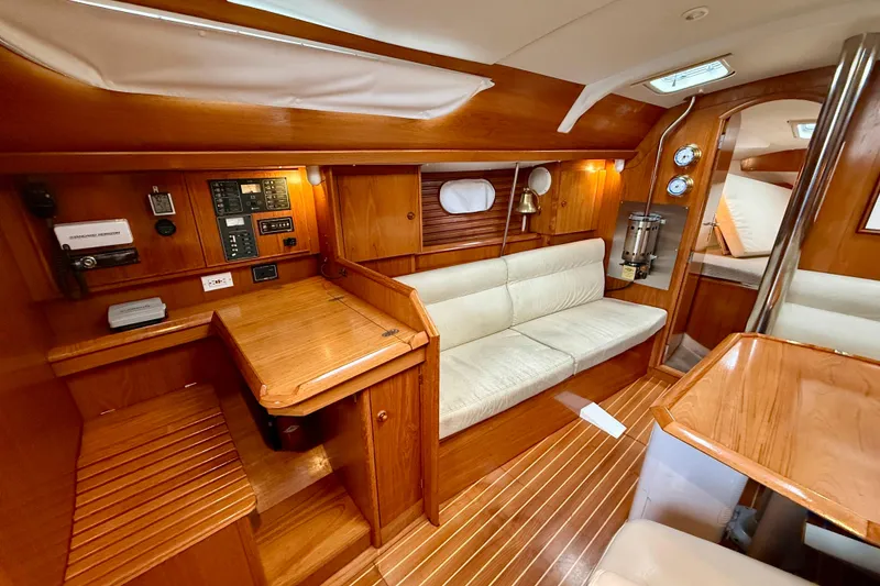 Slide: The Image of Interior of 1997 Jeanneau Sun Odyssey 36.2 yacht with wood finish and cozy seating. - 13