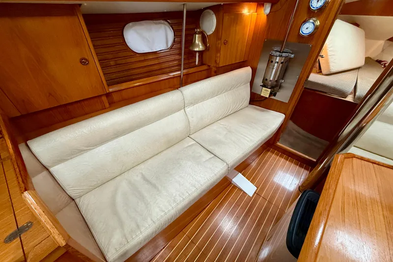 Slide: The Image of Interior of 1997 Jeanneau Sun Odyssey 36.2 sailboat with cozy dining area and wooden table. - 17