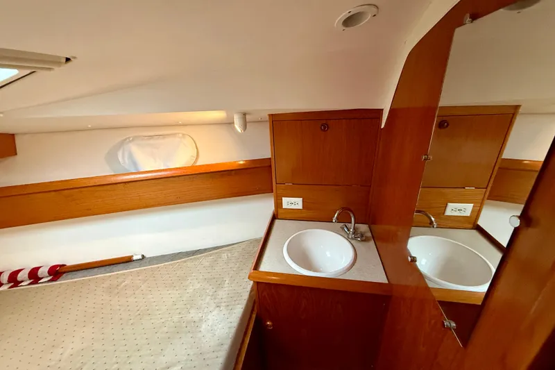 Slide: The Image of Cozy cabin interior of 1997 Jeanneau Sun Odyssey 36.2 sailboat with wooden accents. - 21