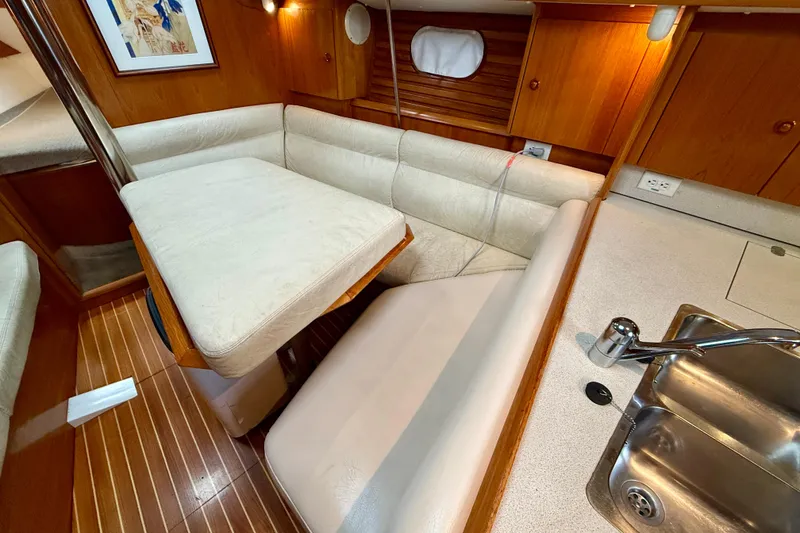 Slide: The Image of Interior of 1997 Jeanneau Sun Odyssey 36.2 yacht with wooden cabinetry and sink. - 22