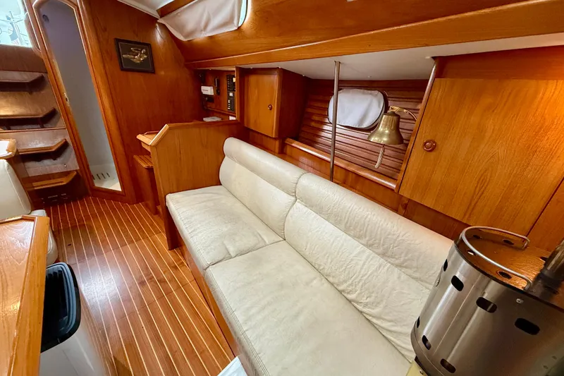 Slide: The Image of Interior of 1997 Jeanneau Sun Odyssey 36.2 sailboat with wood finish and cozy seating. - 24