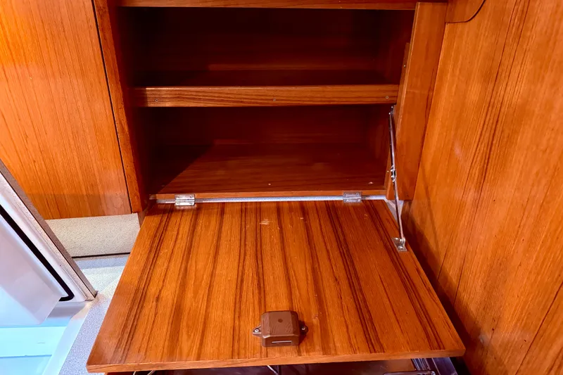 Slide: The Image of Storage compartment on a 1997 Jeanneau Sun Odyssey 36.2 sailboat, featuring organized space. - 30