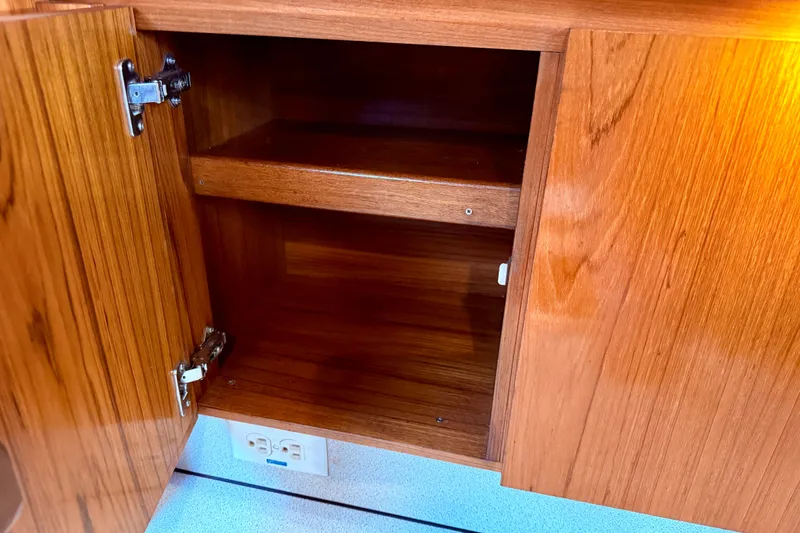 Slide: The Image of Wooden cabinet interior on 1997 Jeanneau Sun Odyssey 36.2 yacht, featuring cup holders. - 32