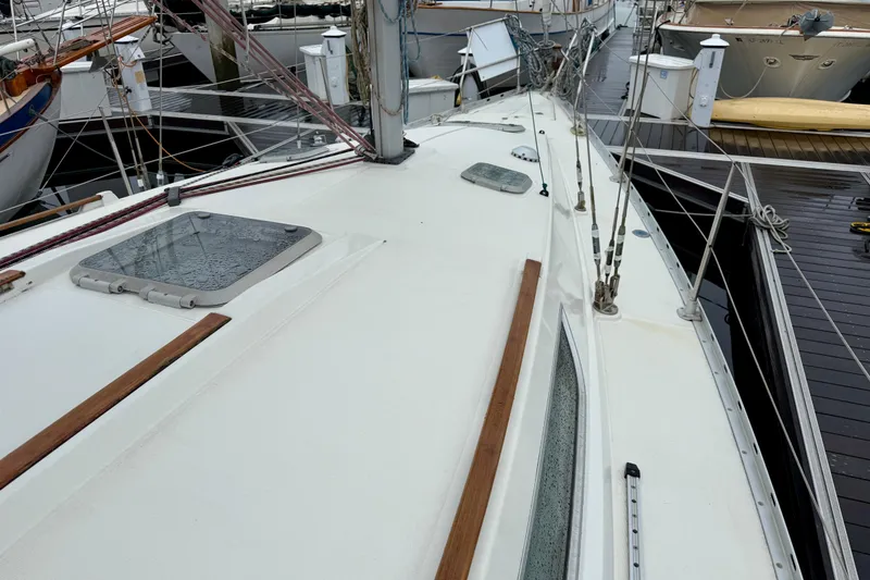 Slide: The Image of Jeanneau Sun Odyssey 36.2 sailboat, 1997 model, with blue canvas cover in marina. - 4