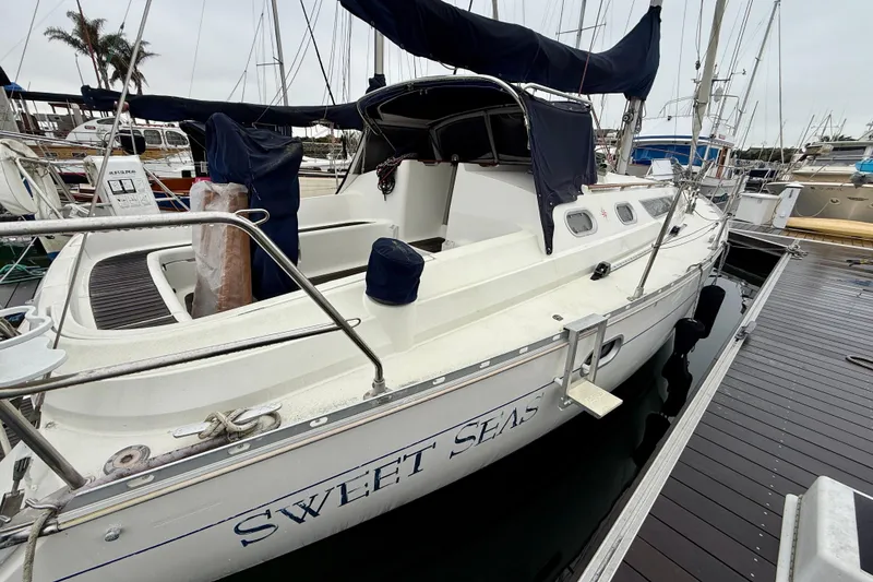 Slide: The Image of 1997 Jeanneau Sun Odyssey 36.2 sailboat docked, featuring a Honda outboard motor. - 6