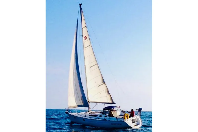 Slide: The Image of 1997 Jeanneau Sun Odyssey 36.2 sailboat docked, named "Sweet Seas," with covered cockpit. - 7