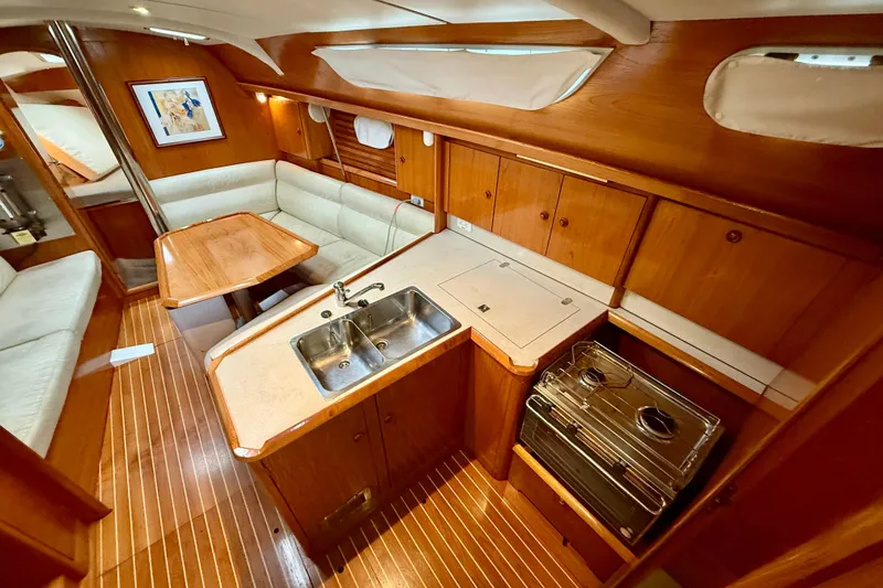 Slide: The Image of Interior of 1997 Jeanneau Sun Odyssey 36.2 sailboat with wood finish and cozy seating. - 9