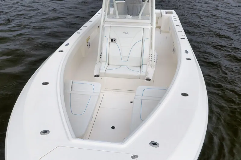 Slide: The Image of 2023 SeaVee 322Z boat with spacious deck and seating on calm water. - 11
