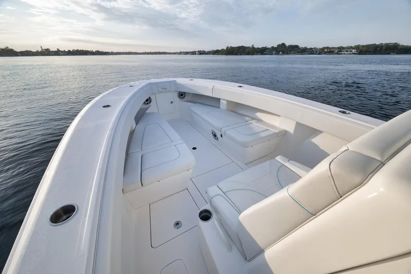 Slide: The Image of 2023 SeaVee 322Z boat interior with white seating, on calm water. - 15