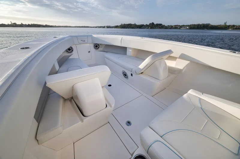 Slide: The Image of 2023 SeaVee 322Z boat interior with white seating, on calm water. - 19