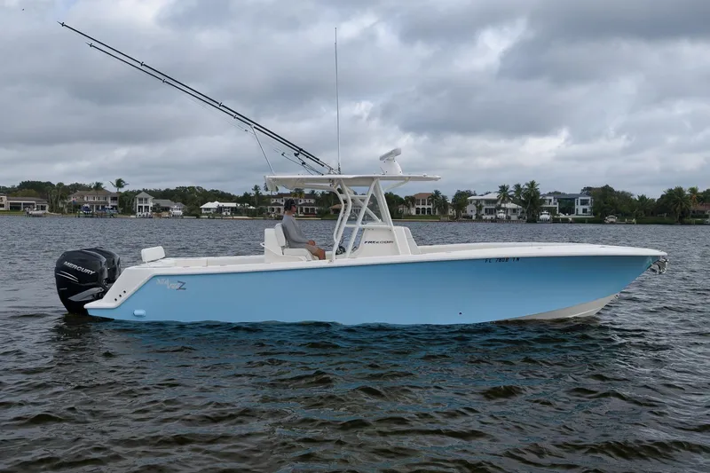 Slide: The Image of 2023 SeaVee 322Z boat on water, featuring sleek design and twin Mercury engines. - 2