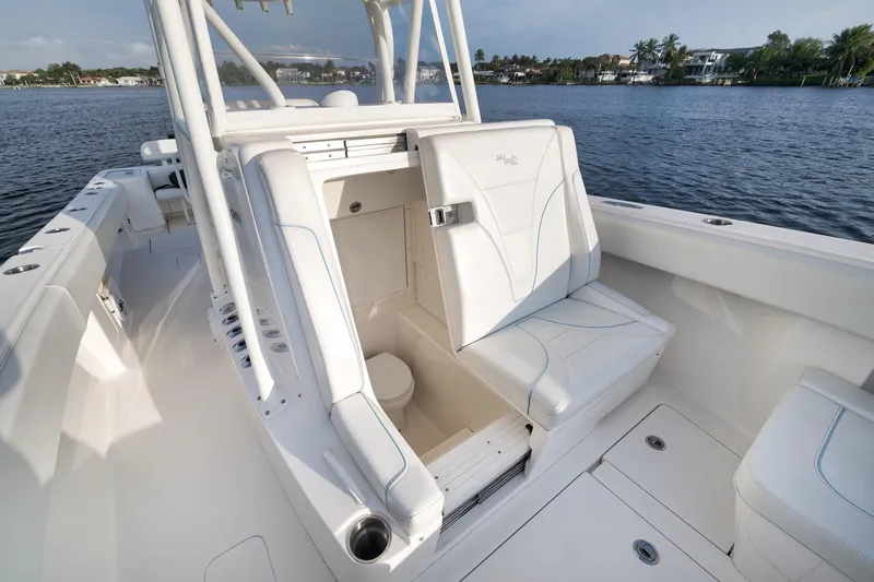 Slide: The Image of 2023 SeaVee 322Z boat interior with white seating and open storage compartment. - 22