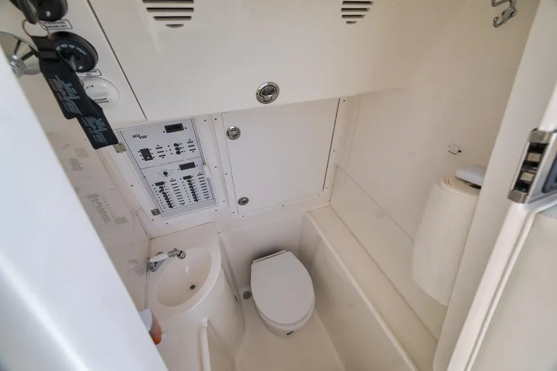 Slide: The Image of 2023 SeaVee 322Z boat interior with toilet, sink, and control panel. - 23