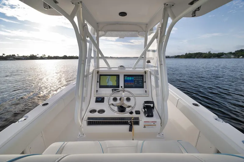 Slide: The Image of 2023 SeaVee 322Z boat cockpit with modern navigation system on calm water. - 28