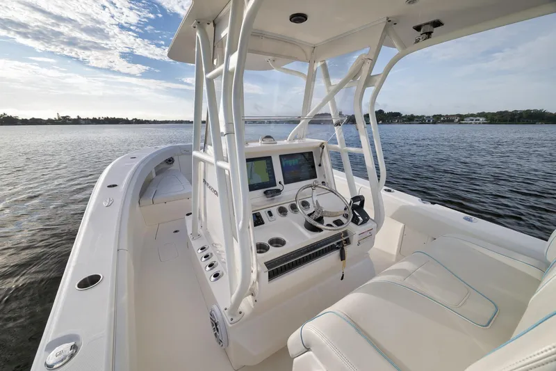 Slide: The Image of 2023 SeaVee 322Z boat interior with modern helm and seating on calm water. - 29