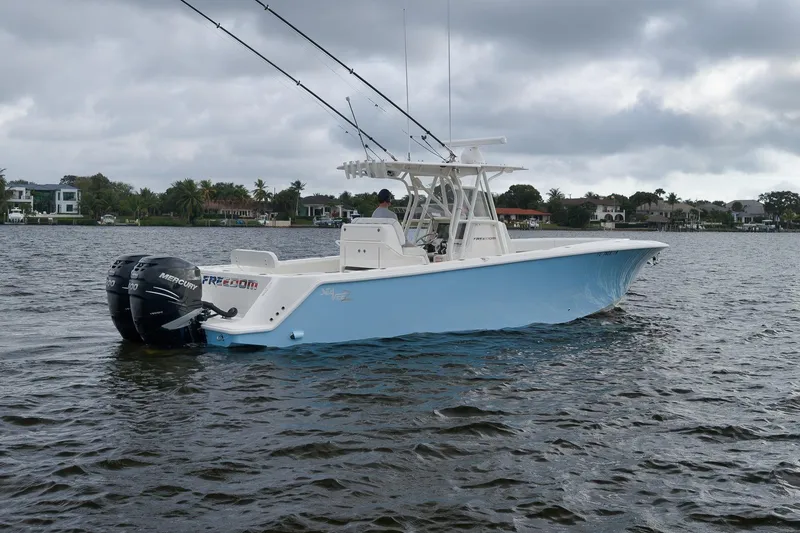 Slide: The Image of 2023 SeaVee 322Z boat on water with dual Mercury engines, overcast sky. - 3