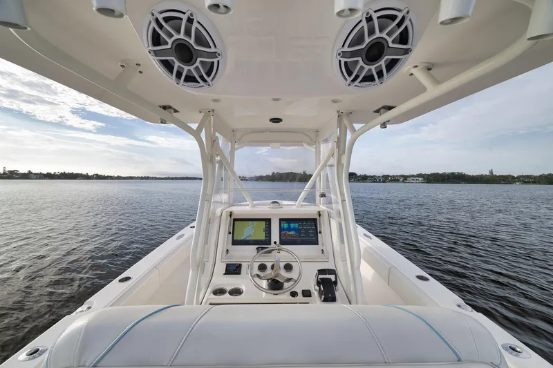 Slide: The Image of 2023 SeaVee 322Z boat interior with navigation system, speakers, and open water view. - 33