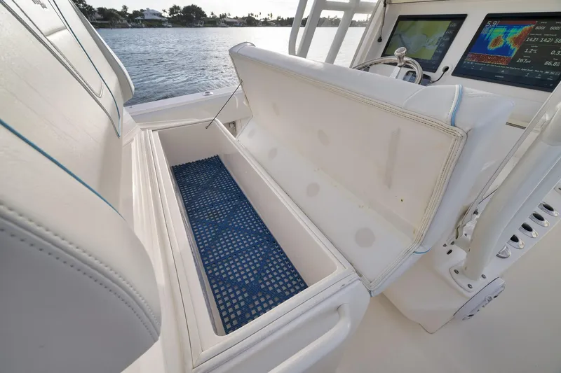 Slide: The Image of 2023 SeaVee 322Z boat interior with open storage compartment and navigation screens. - 37