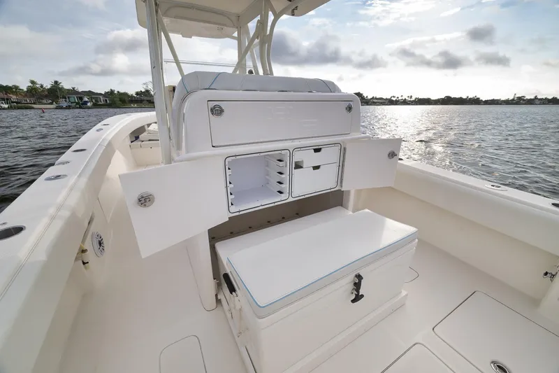 Slide: The Image of 2023 SeaVee 322Z boat interior with open storage compartments on a sunny day. - 39