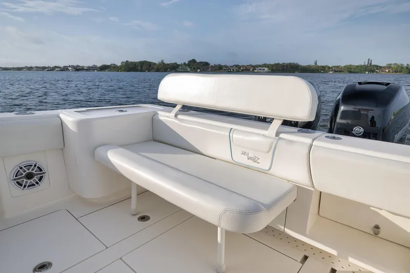 Slide: The Image of 2023 SeaVee 322Z boat with white seating, on a calm water backdrop. - 41