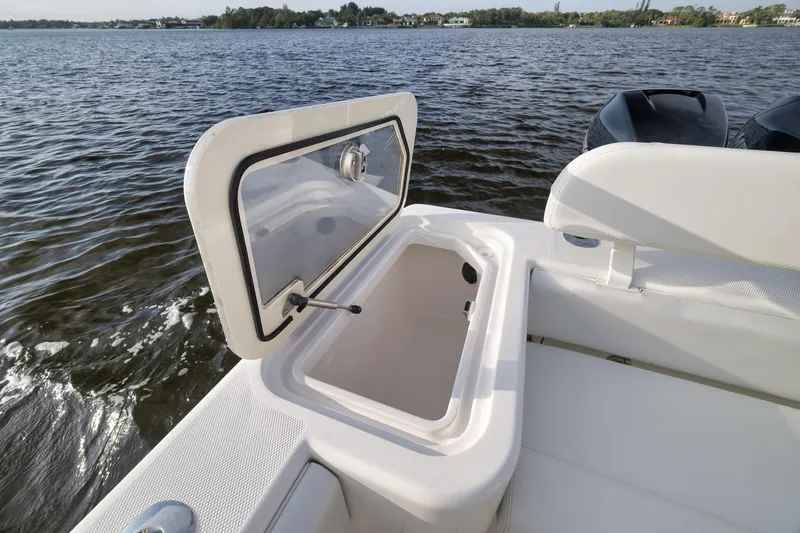 Slide: The Image of 2023 SeaVee 322Z boat with open storage compartment on calm water. - 44