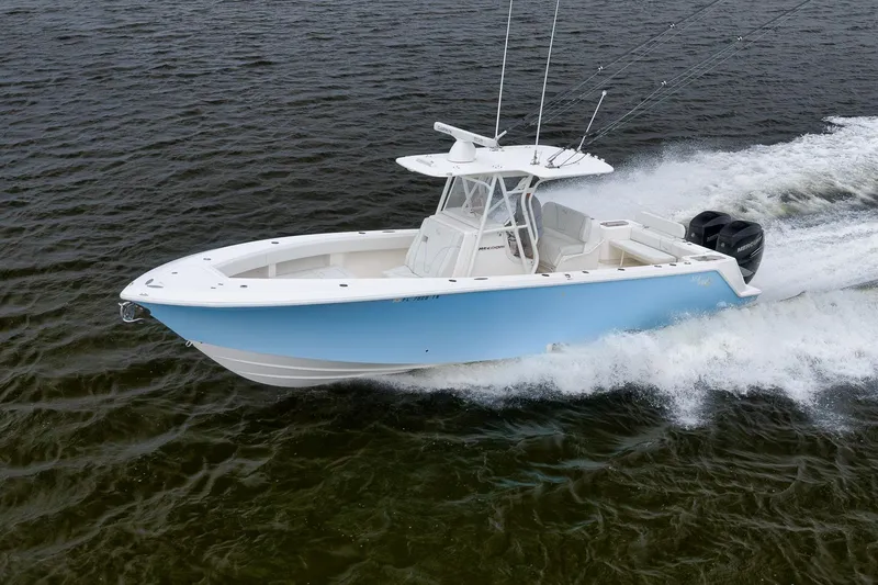 Slide: The Image of 2023 SeaVee 322Z boat cruising on open water, showcasing sleek design and powerful engines. - 52