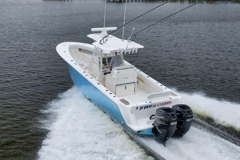 Slide: The Image of 2023 SeaVee 322Z boat cruising on water with dual Mercury engines. - 54