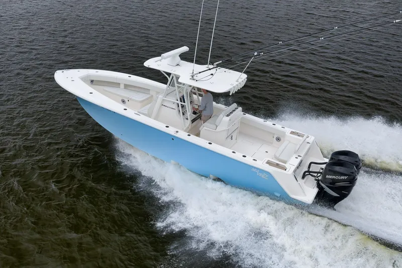 Slide: The Image of 2023 SeaVee 322Z boat cruising on water with dual Mercury engines. - 55