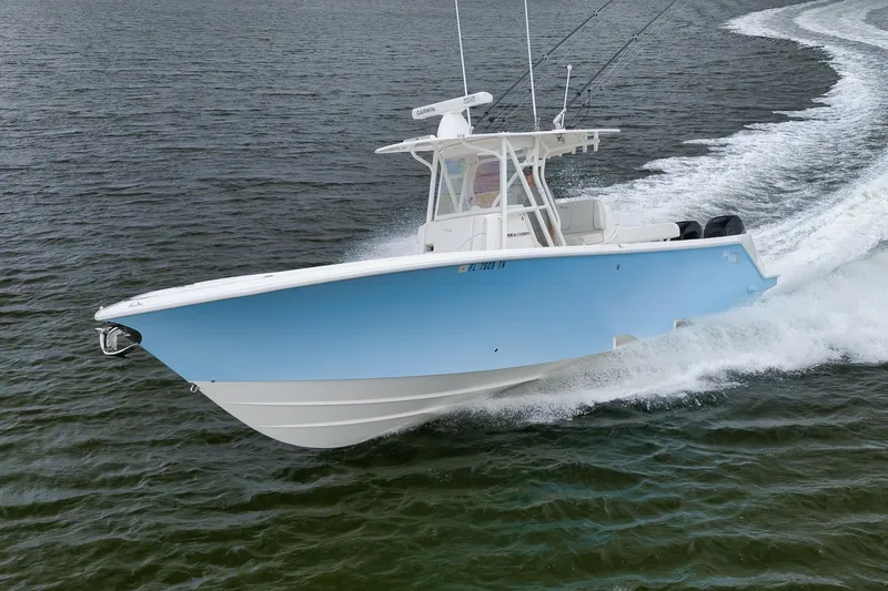 Slide: The Image of 2023 SeaVee 322Z boat cruising on open water, showcasing sleek design and performance. - 56