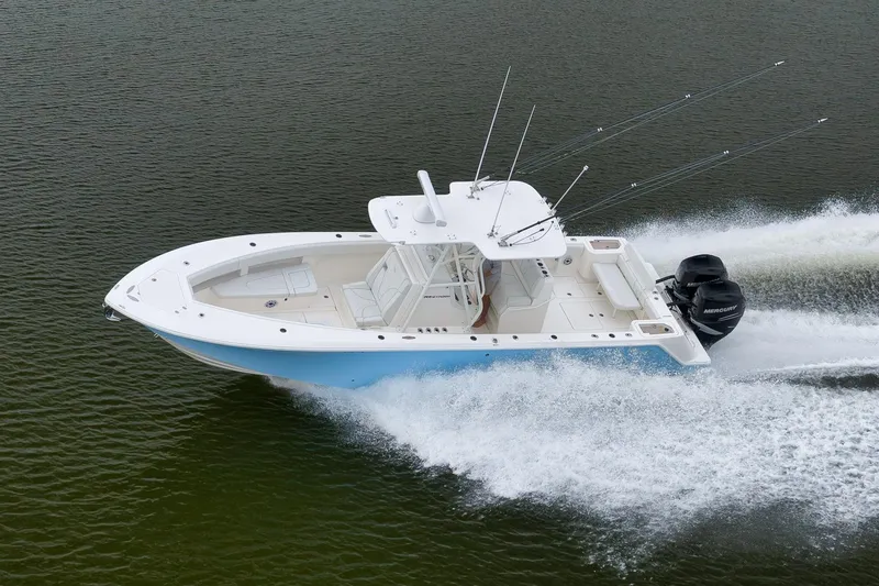 Slide: The Image of 2023 SeaVee 322Z boat cruising on water with dual outboard engines. - 58