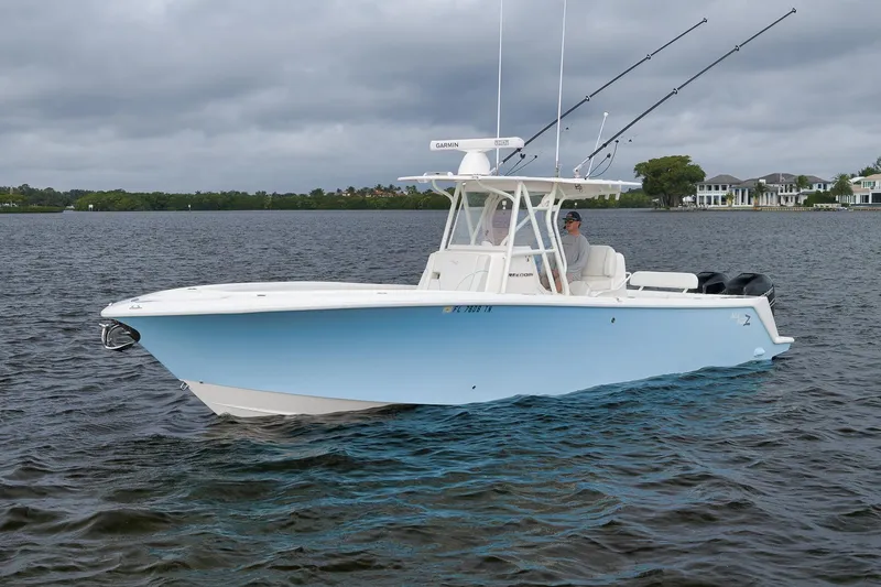 Slide: The Image of 2023 SeaVee 322Z boat on water, featuring fishing rods and modern design. - 6