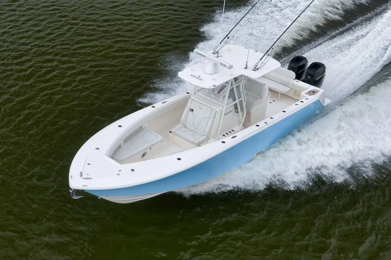 Slide: The Image of 2023 SeaVee 322Z boat cruising on water, showcasing sleek design and powerful engines. - 61