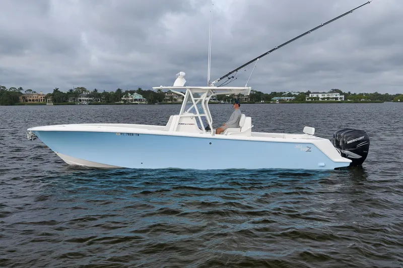 Slide: The Image of 2023 SeaVee 322Z boat on water, featuring sleek design and powerful Mercury engines. - 7