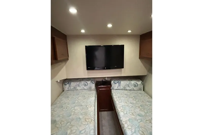 Slide: The Image of Interior of 1988 Ocean Yachts 48 Super Sport with twin beds and wall-mounted TV. - 10