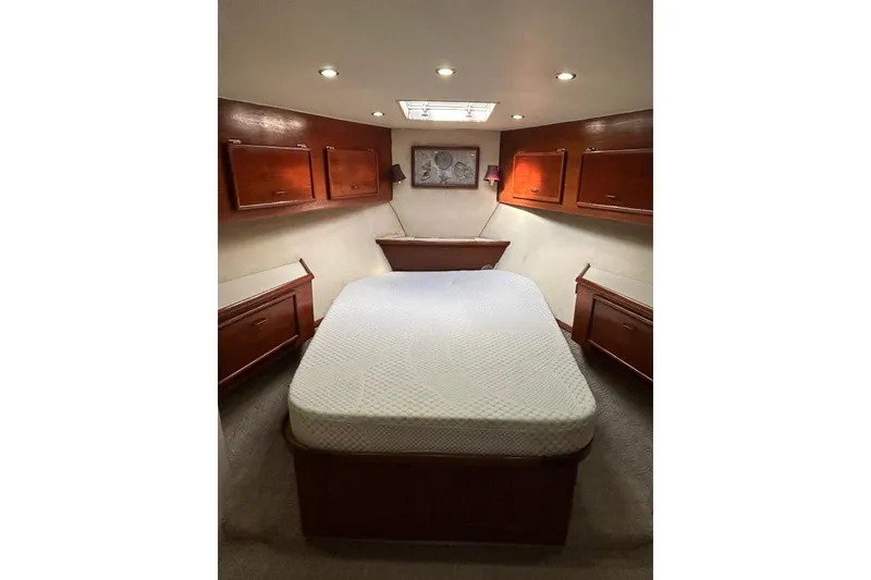 Slide: The Image of Luxurious cabin interior of 1988 Ocean Yachts 48 Super Sport with cozy bed and wooden cabinets. - 12