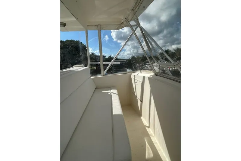Slide: The Image of 1988 Ocean Yachts 48 Super Sport interior with white seating and clear skies. - 16