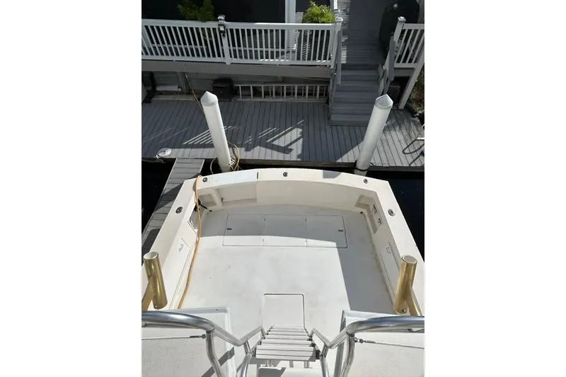 Slide: The Image of 1988 Ocean Yachts 48 Super Sport boat deck with dock view, featuring spacious layout. - 5