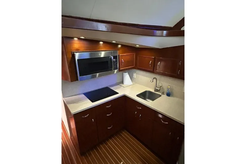 Slide: The Image of Luxurious kitchen in 1988 Ocean Yachts 48 Super Sport with modern appliances and wood cabinetry. - 9